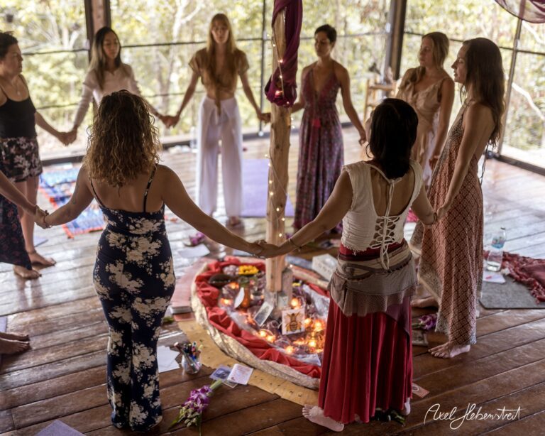 Frauen halten sich in einer spirituellen Zeremonie in einem lichtdurchfluteten Raum die Hände – © Axel Hebenstreit